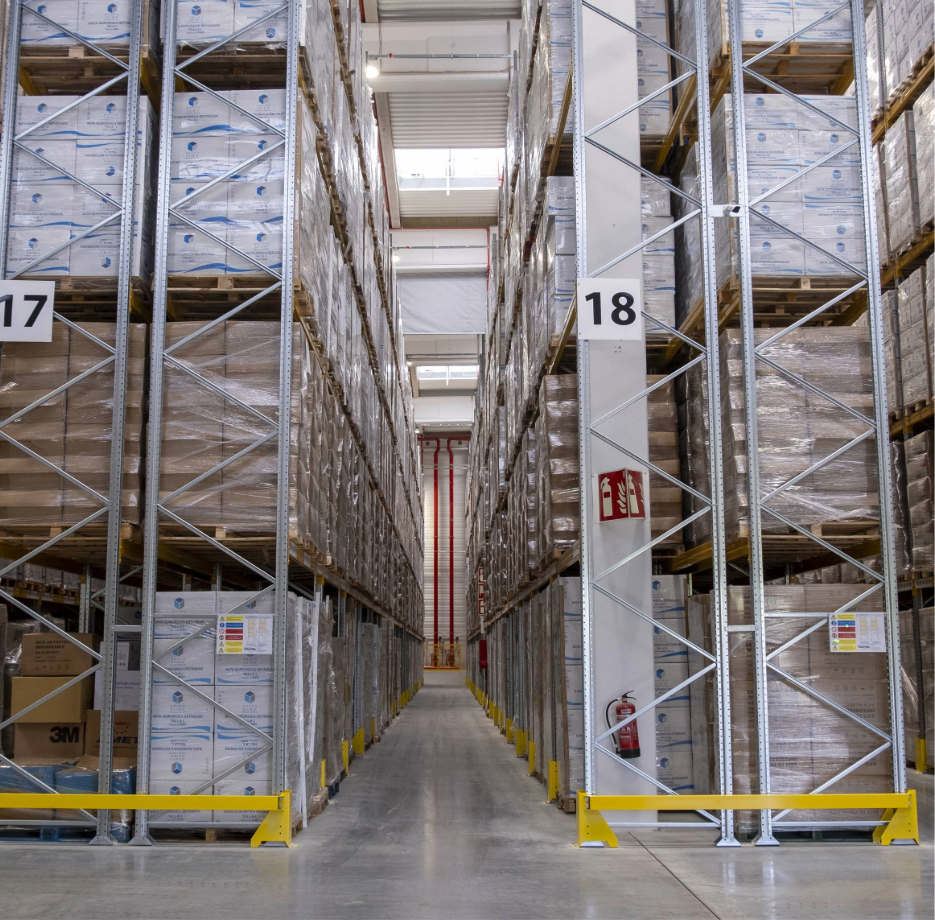 Narrow aisle racking system in a warehouse designed for high-density pallet storage.