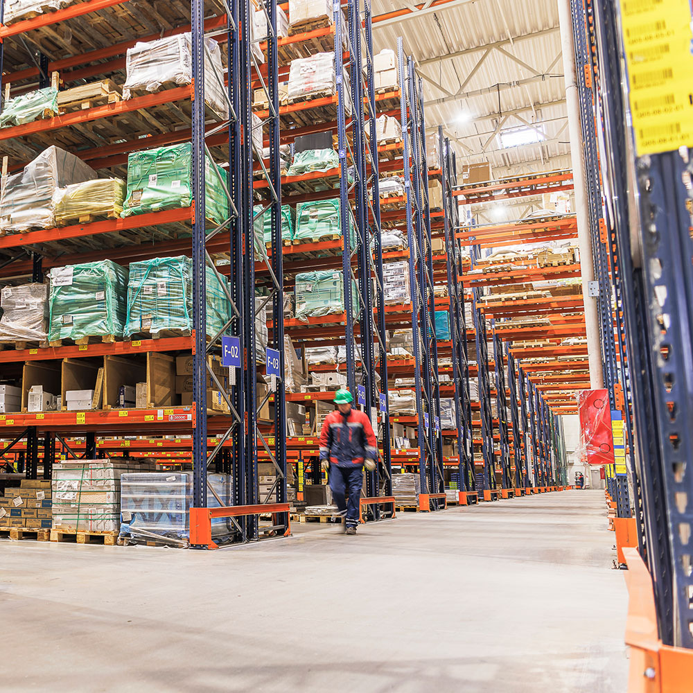 Man walking in warehouse with Racking