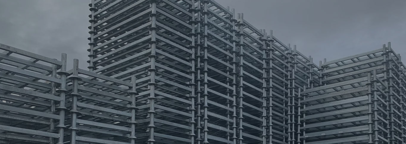 Yard with stillages stacked to up in the image